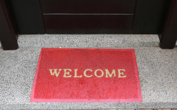 房前的红色门垫上写着欢迎短信。图片下载