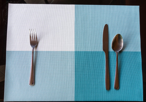 顶视图的蓝色桌子垫与银匙图片下载