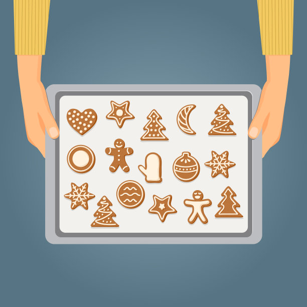 手拿着烤盘和圣诞饼干图片下载