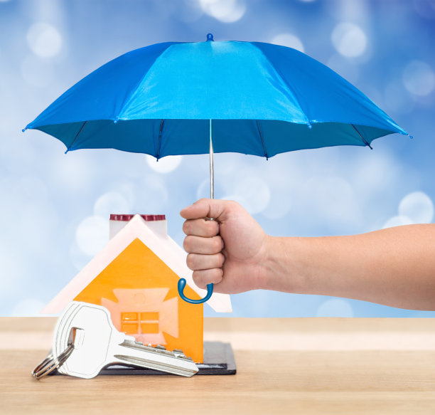 房子和钥匙下的蓝色伞保护财产概念图片下载