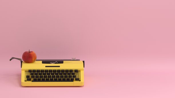 打字机和水果苹果在桌子上五颜六色的教育在粉红色的墙前面可爱的图片为复制空间最小的水果和物体概念柔和彩色可爱的艺术图片下载
