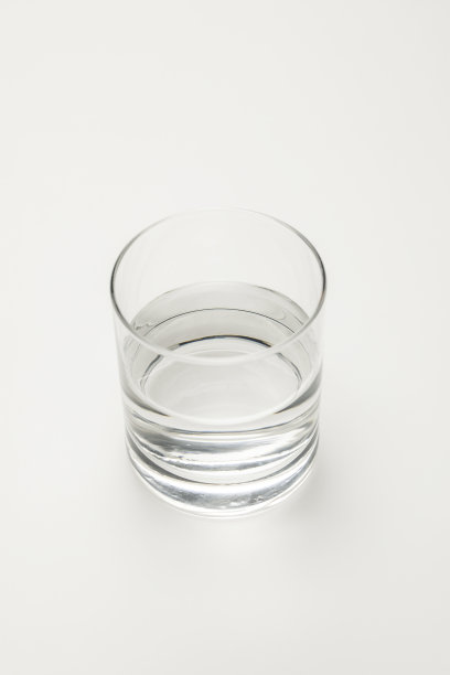 头顶的透明玻璃与平静的矿泉水隔离在白色图片下载