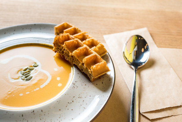 白碗比利时华夫饼南瓜奶油汤。传统的秋季食品。照片来自家庭厨房或家庭咖啡馆图片下载