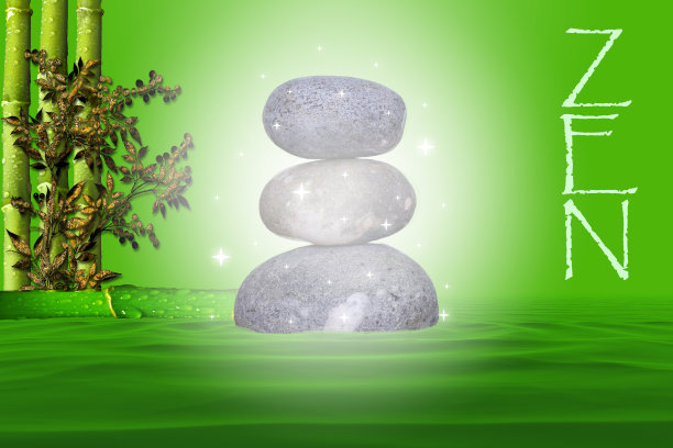 用竹子和树叶在河床上以禅宗的方式堆叠在绿色背景上的天然魔法石图片下载