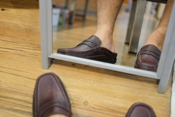一个男人在鞋店里穿着经典的皮鞋图片下载