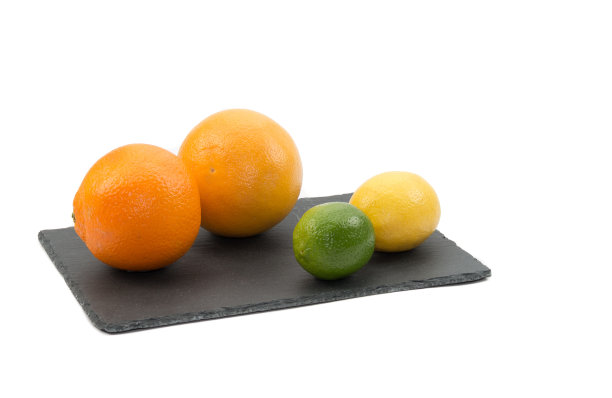柑橘类水果，橘子，粉红葡萄柚，柠檬和酸橙在黑色板板与白色背景图片下载