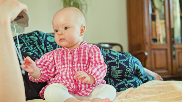 婴儿坐着玩玩具图片下载