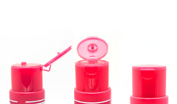 白色背景上开盖的粉色塑料化妆瓶图片下载