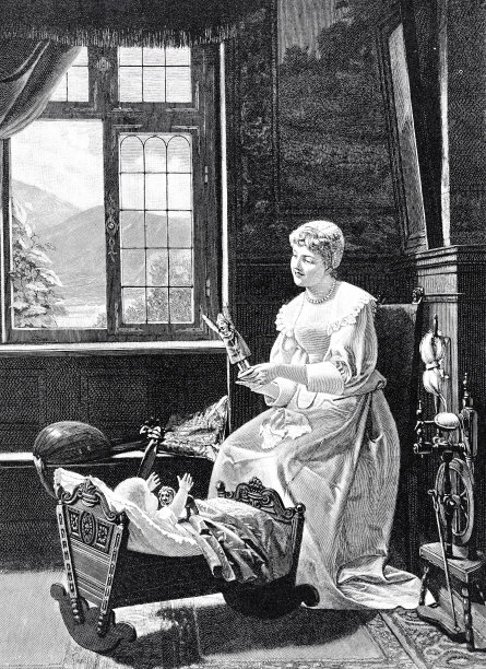 妈妈和躺在床上的婴儿玩图片下载