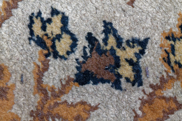 波斯地毯纹理，抽象宏花点缀。中东传统地毯织物背景图片下载