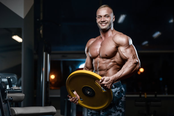 野蛮强壮的健美运动员用哑铃锻炼肌肉图片下载