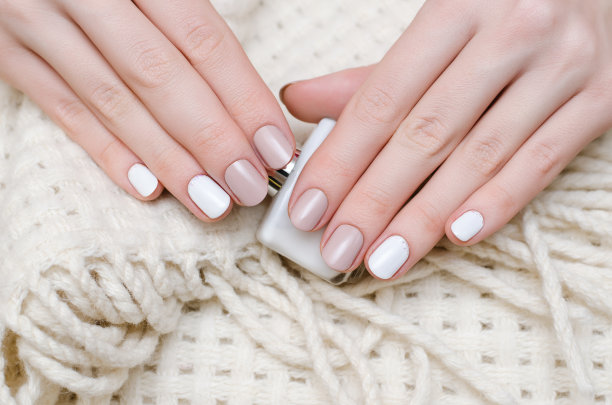 女性手与白色指甲设计。图片下载