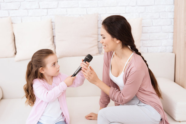 妈妈和女儿在家唱歌。图片下载