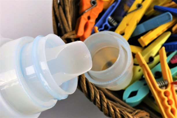 一个概念图像一些彩色的衣夹与液体洗涤剂图片下载