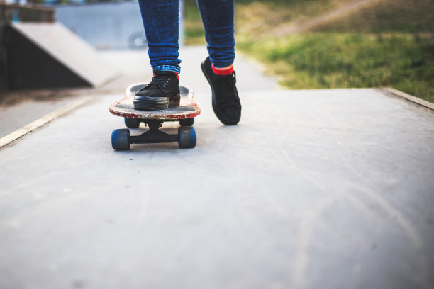 女孩的脚踩在滑板上。副本的空间。图片下载