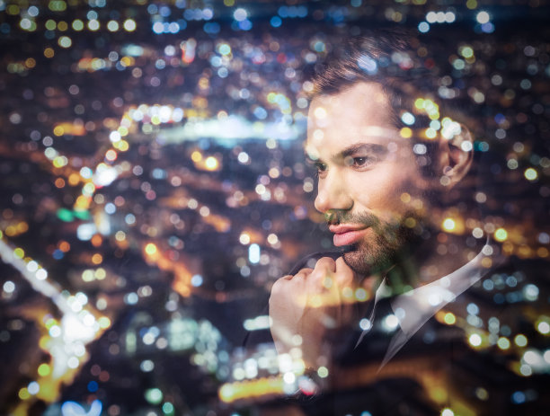 年轻的商人的想法。双重曝光城市背景。图片下载