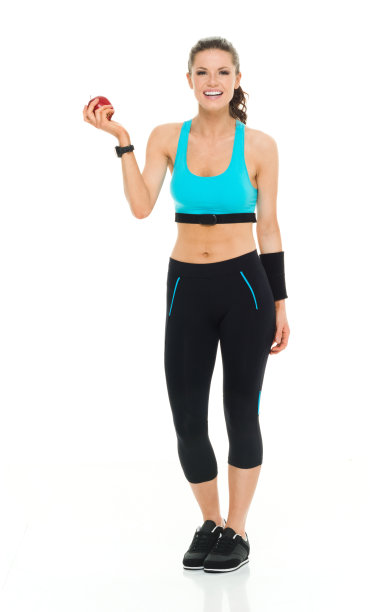 穿着运动服拿着苹果的女人图片下载