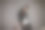 近距离的时尚英俊的深思熟虑的长发绺溜冰者站在灰色的墙在西装听音乐和看在地板与滑板旁边他。图片下载