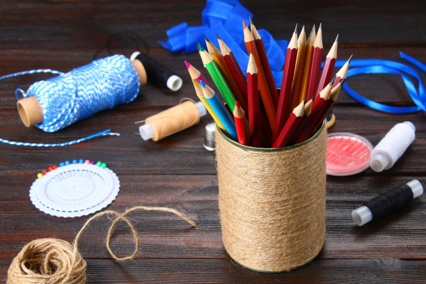 木制桌子上放着用绳子包着心形的铅笔。手工制作的。图片下载