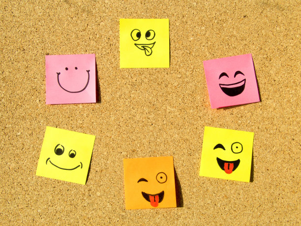 用不同表情的便利贴贴在软木板办公室学校抽象概念照片上图片下载