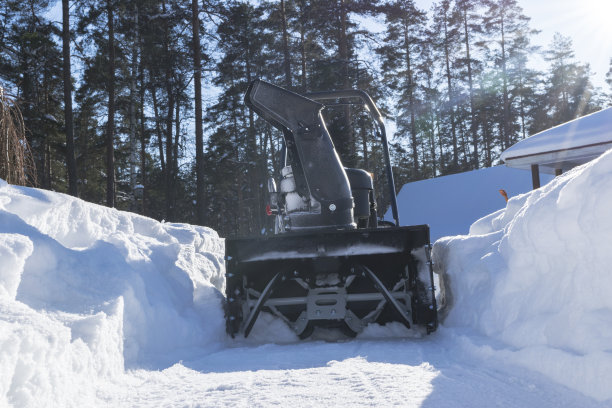 吹雪机在冬天工作。暴风雪过后扫雪机扫雪。清除冰。除雪机。用吹雪机清理车道。除雪机。雪犁。图片下载