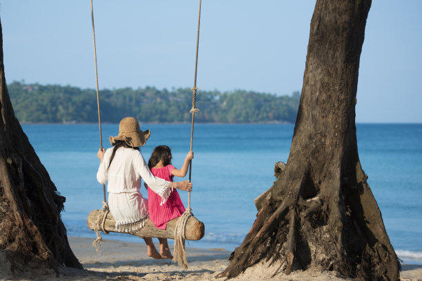 妈妈和女儿在沙滩上玩秋千图片下载