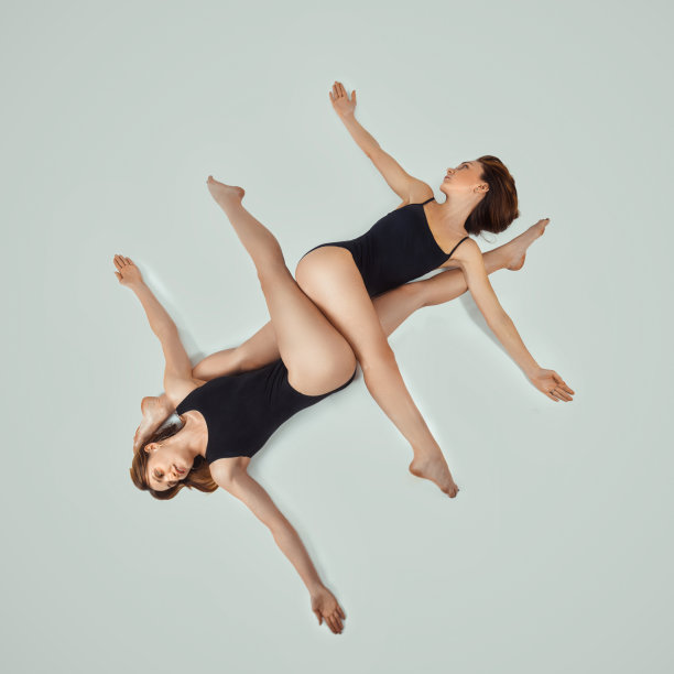 灰色背景上两个漂亮的年轻女人的肖像。女性身体的美丽图片下载