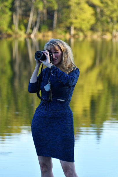 五十多岁的女人在湖边拍照图片下载