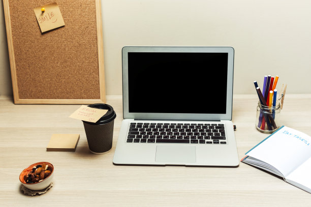 一张有电脑、笔记本和其他小物件的桌子图片下载