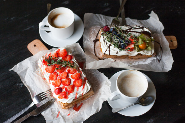 比利时华夫饼，新鲜的浆果和鲜奶油，乡村风格的砧板上，黑色的桌子。早餐的概念。前视图。平躺图片下载