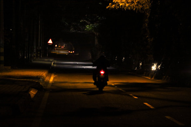 孤独的骑手在荒凉黑暗的街道上图片下载