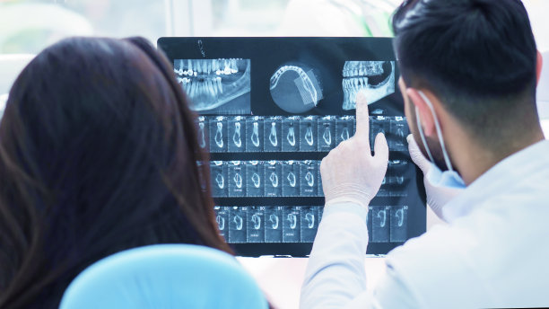 牙医给病人看她的x光片素材图片