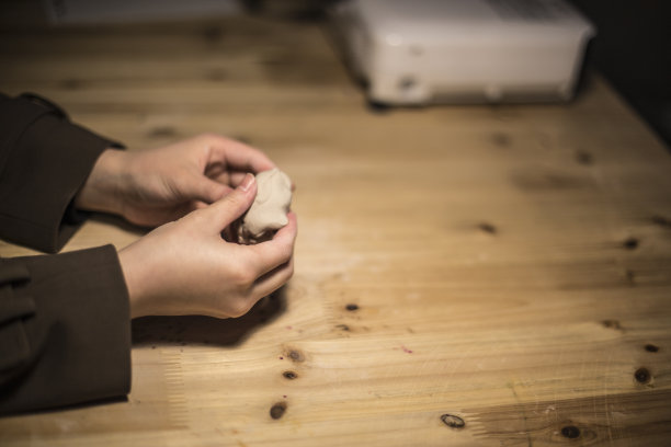 青少年在陶艺作坊制作陶土碗。素材图片