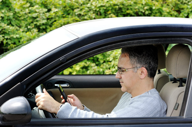 手里拿着智能手机开车的男人图片下载