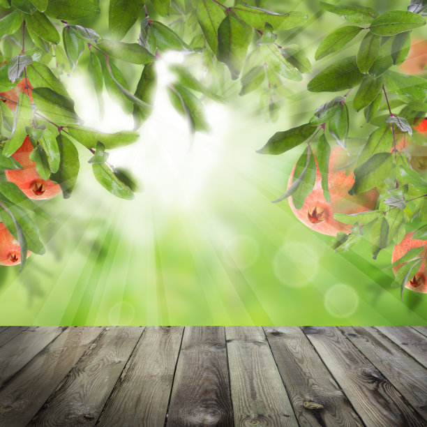 石榴水果和绿叶在抽象的背景与灰色空木桌图片下载