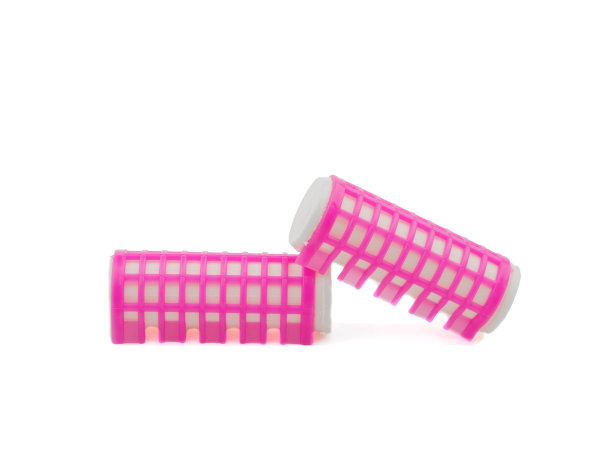 白色背景上的粉色卷发器图片下载