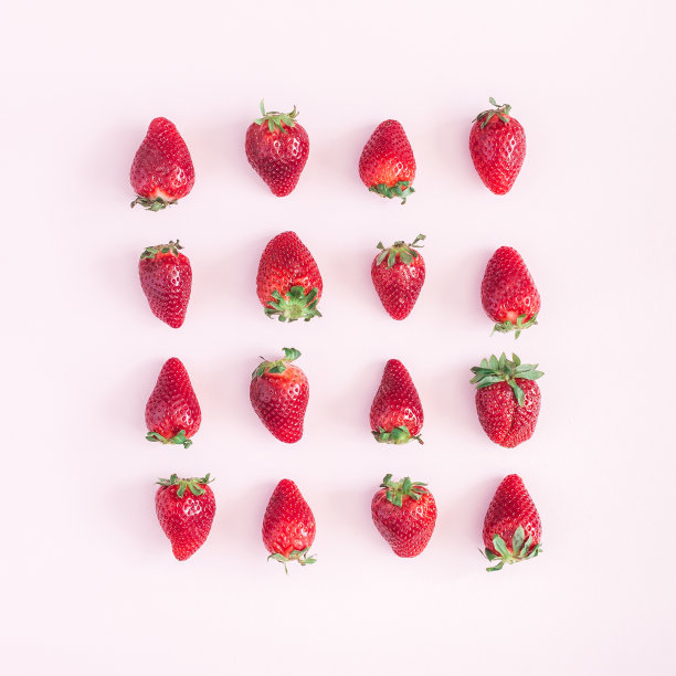 粉色背景上的草莓图案。平躺，俯视图，正方形图片下载