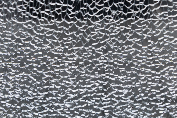 破碎镜面纹理背景。在玻璃窗背景上施加强力而产生的抽象裂纹图案图片下载