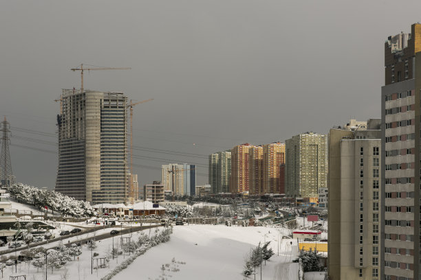 在土耳其伊斯坦布尔，阿塔希尔金融区附近的摩天大楼在冬季的雪中图片下载