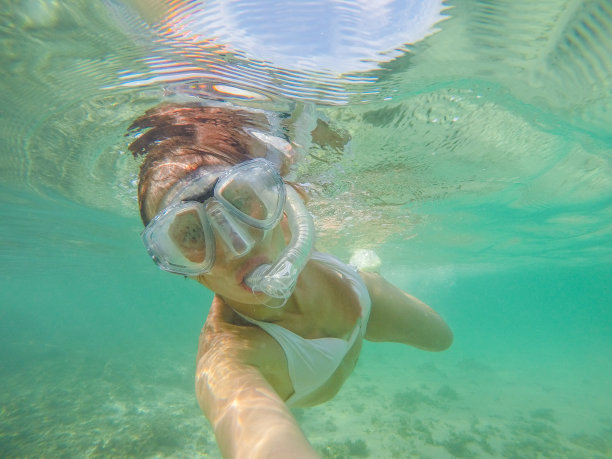 水下自拍的女孩在水晶蓝色的水，度假夏天的概念图片下载