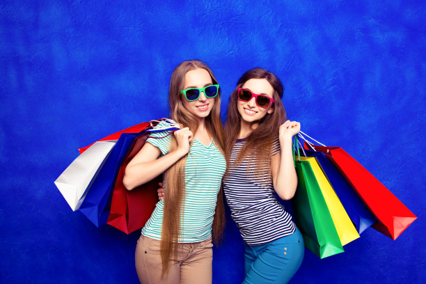 漂亮快乐的顾客在购物后戴着眼镜和包装图片下载