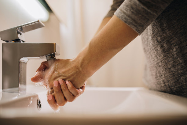 不认识的女性在浴室洗手。图片下载