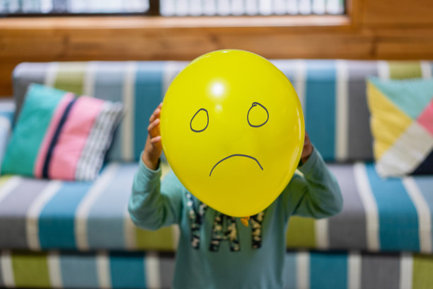 孩子用爱气球遮住脸。图片下载