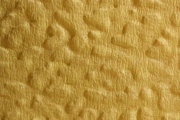 黄色的餐巾纹理。浮雕装饰装饰背景。图片下载