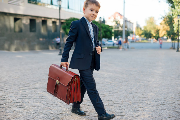 未来的商人穿着正装，拿着公文包图片下载