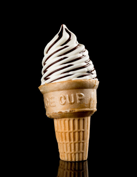 在黑色背景下，冰淇淋甜筒正在融化，眼看就要倒下来图片下载