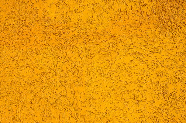 纹理。真正有纹理的石膏漆成橙色。这张照片是在街上拍摄的，拍摄的是一幢修缮后的真实建筑的墙壁。图片下载