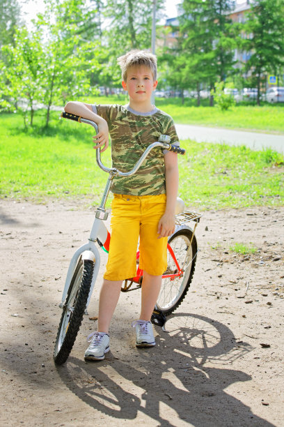 快乐的脸红男孩青少年完成训练的自行车图片下载