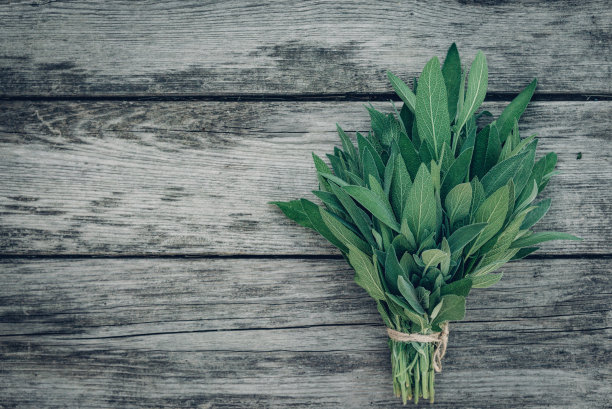 鼠尾草officinalis。鼠尾草叶子在旧木桌上。花园的圣人。乡村木箱和手工花边。复古的杂志图片。本空间图片下载
