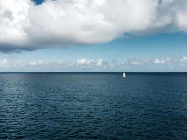 在蔚蓝大海中航行的白色船只图片下载